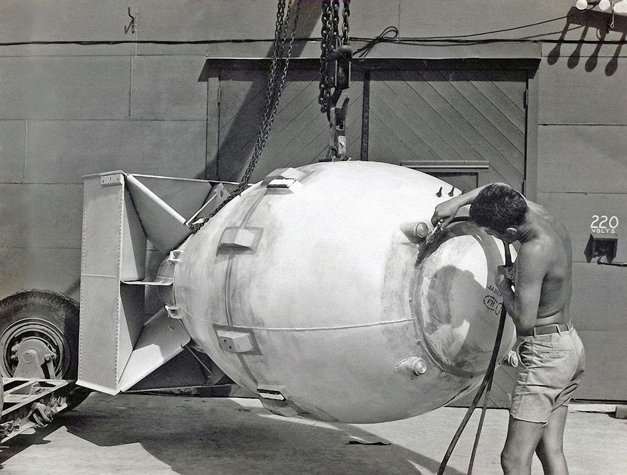 A worker stands next to an atomic bomb, code name "Fat Man," hours before it was dropped on Nagasaki, Japan, on August 9, 1945. The Hiroshima bomb was nicknamed "Little Boy."