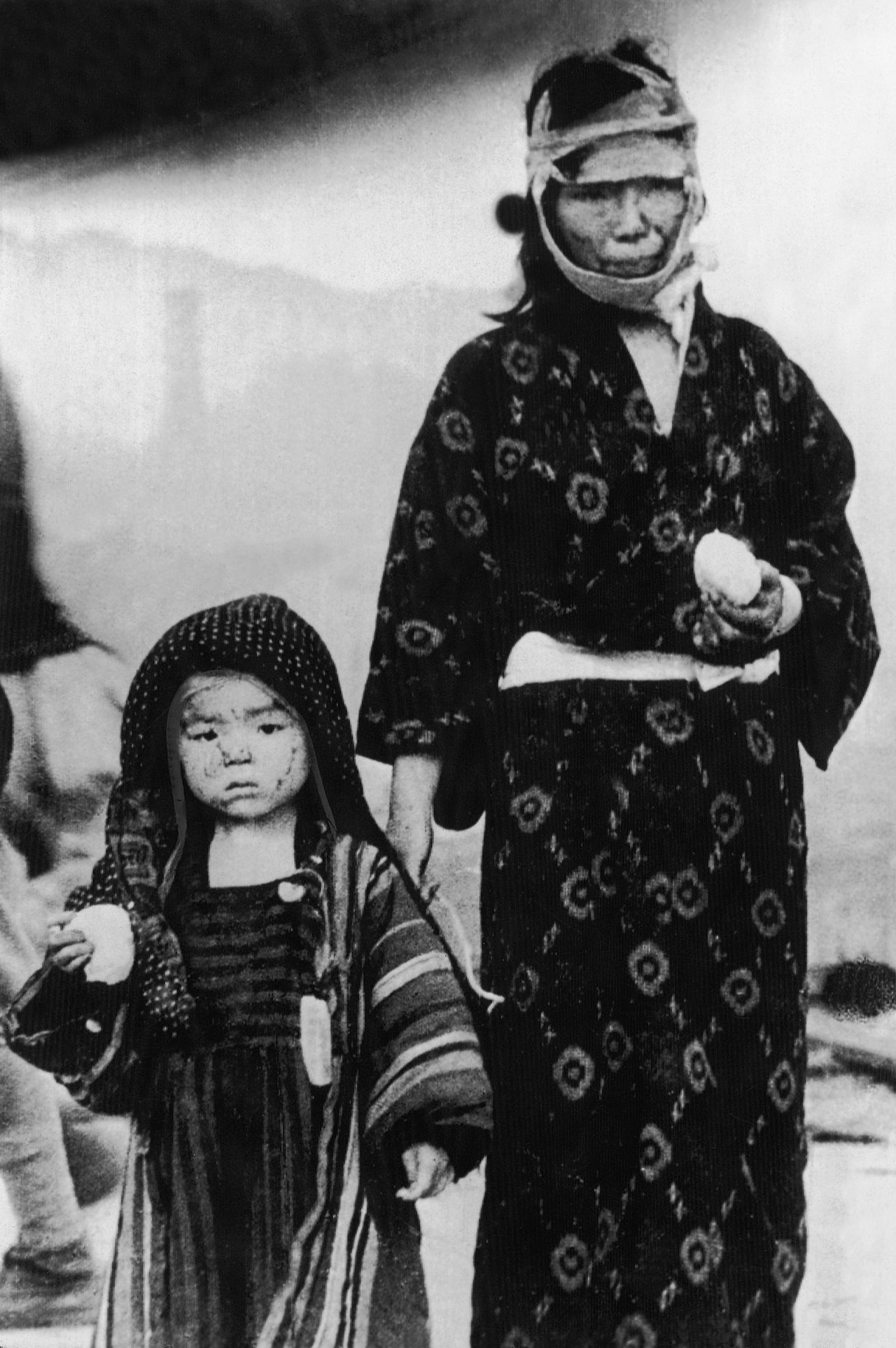 A woman and a child walk in Nagasaki on the day of the bombing.