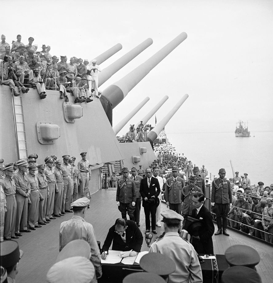 Soldiers and sailors on the USS Missouri watch as Japan's formal surrender is signed in Tokyo Bay on September 2, 1945. 