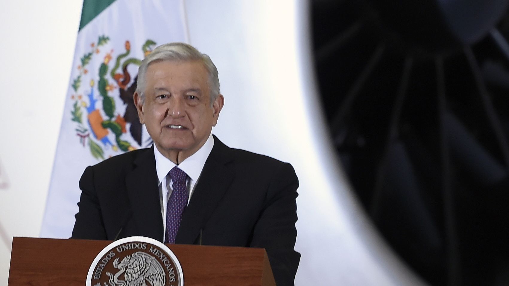 Mexican President Andres Manuel Lopez Obrador speaks during press conference, with the presidential plane in the background on July 27, 2020.
