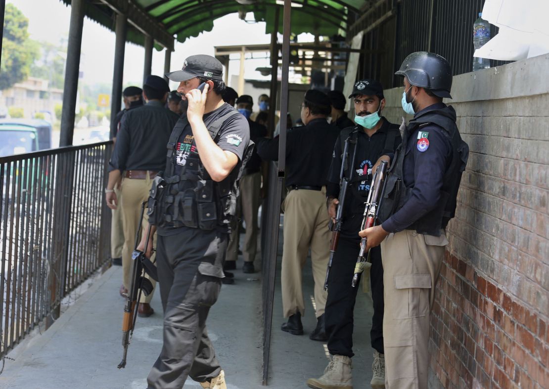 Police officers gather at an entry gate of district court following the killing of Tahir Shamim Ahmad, who was in court accused of blasphemy, in Peshawar, Pakistan, on July 29, 2020. 