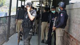Police officers gather at an entry gate of a district court following the killing of Tahir Shamim Ahmad, who was in court accused of blasphemy, in Peshawar, Pakistan, on July 29, 2020. 