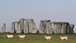 Sheep graze as security guards patrol the prehistoric monument at Stonehenge in southern England, on April 26, 2020, closed during the national lockdown due to the novel coronavirus COVID-19 pandemic. (Photo by Adrian Dennis/AFP/Getty Images)