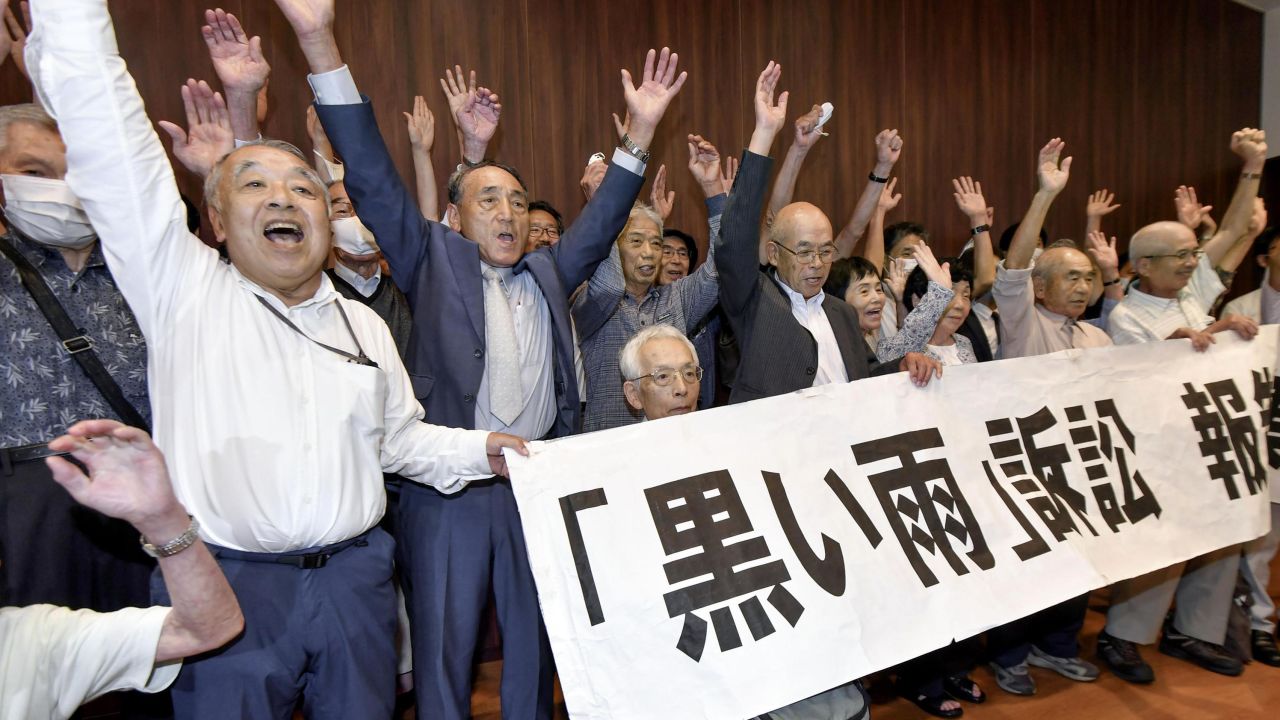 A group of plaintiffs and supporters celebrate after the Hiroshima court ruling on July 29, 2020.