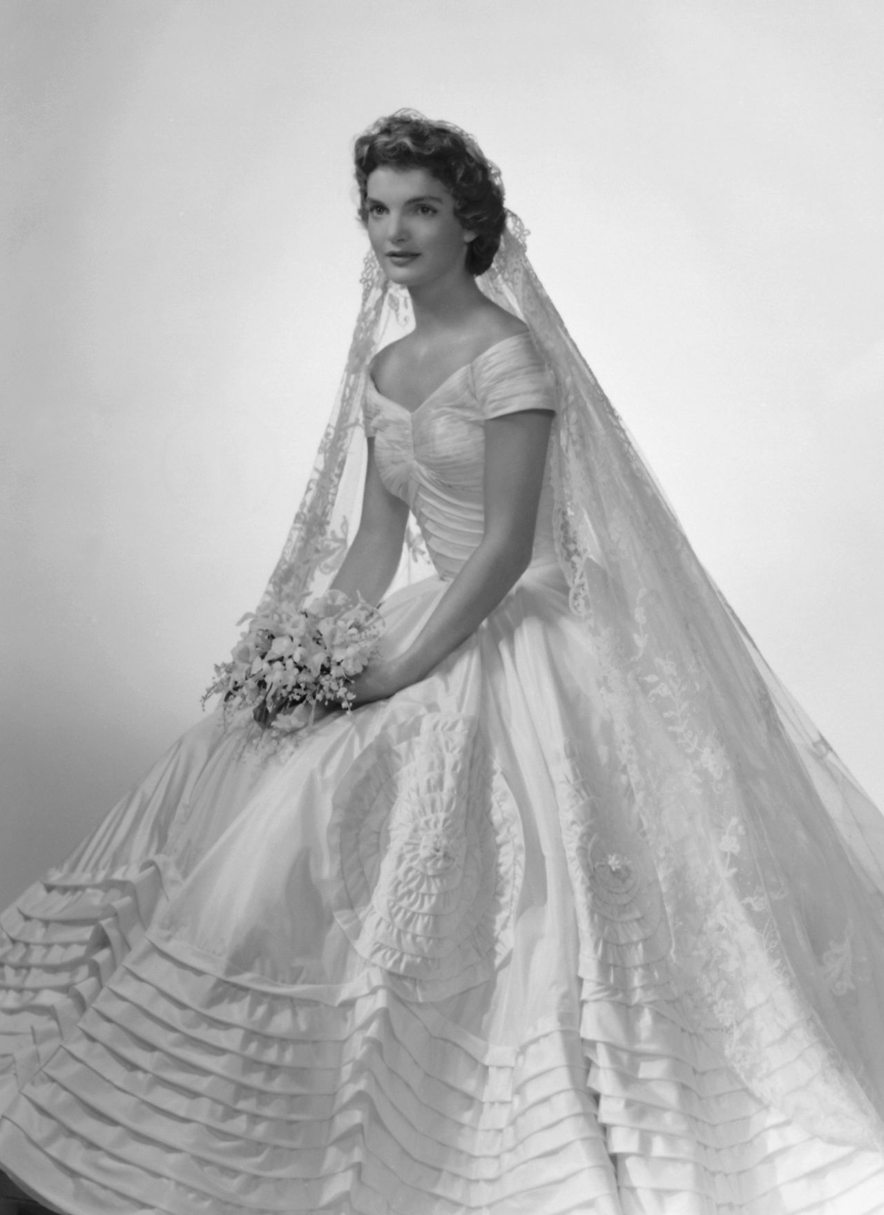 This bridal portrait of Jackie Kennedy captures the finery of her Ann Lowe-designed wedding dress.