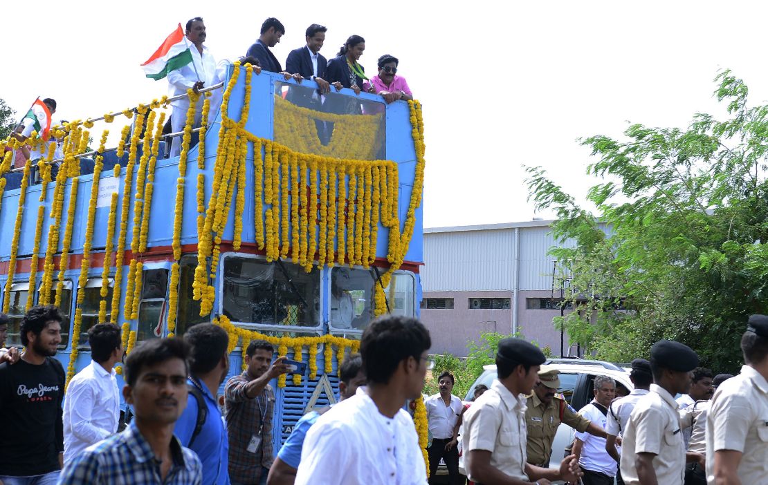 Swelling with pride: Sindhu (2R) is given a hero's welcome in Hyderabad with people lining the streets from the Aiport to the Gopichand Badminton Academy