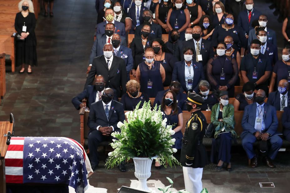 People wear face masks during Thursday's funeral.