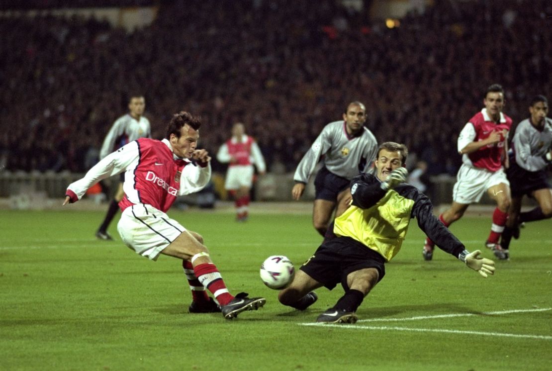 Francesc Arnau blocks a shot by Arsenal's Freddie Ljungberg during the 1999-2000 Champions League.