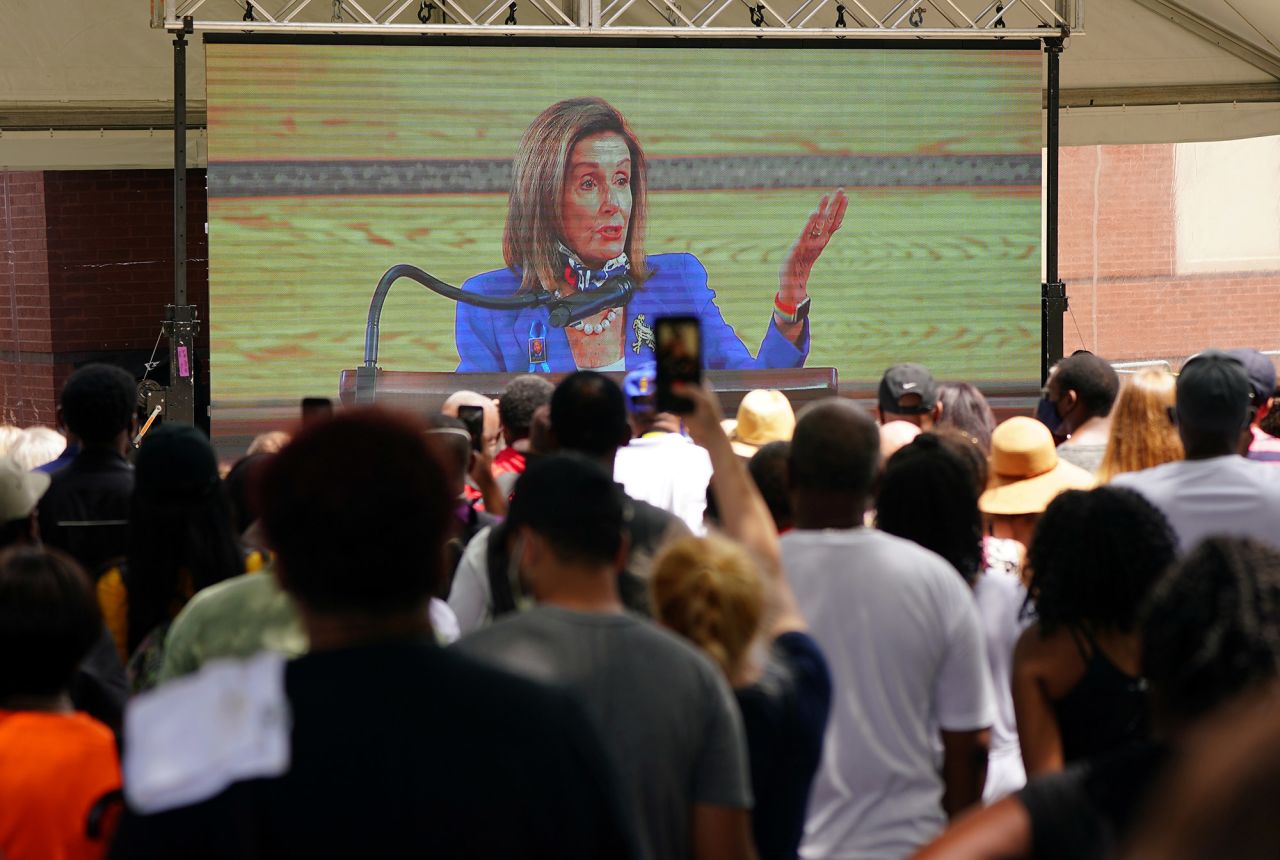 People watch Lewis' funeral outside the church. House Speaker Nancy Pelosi was making remarks at the time.