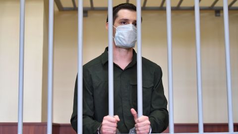 US ex-marine Trevor Reed, charged with attacking police, stands inside a defendants' cage during his verdict hearing at Moscow's Golovinsky district court on July 30, 2020. 