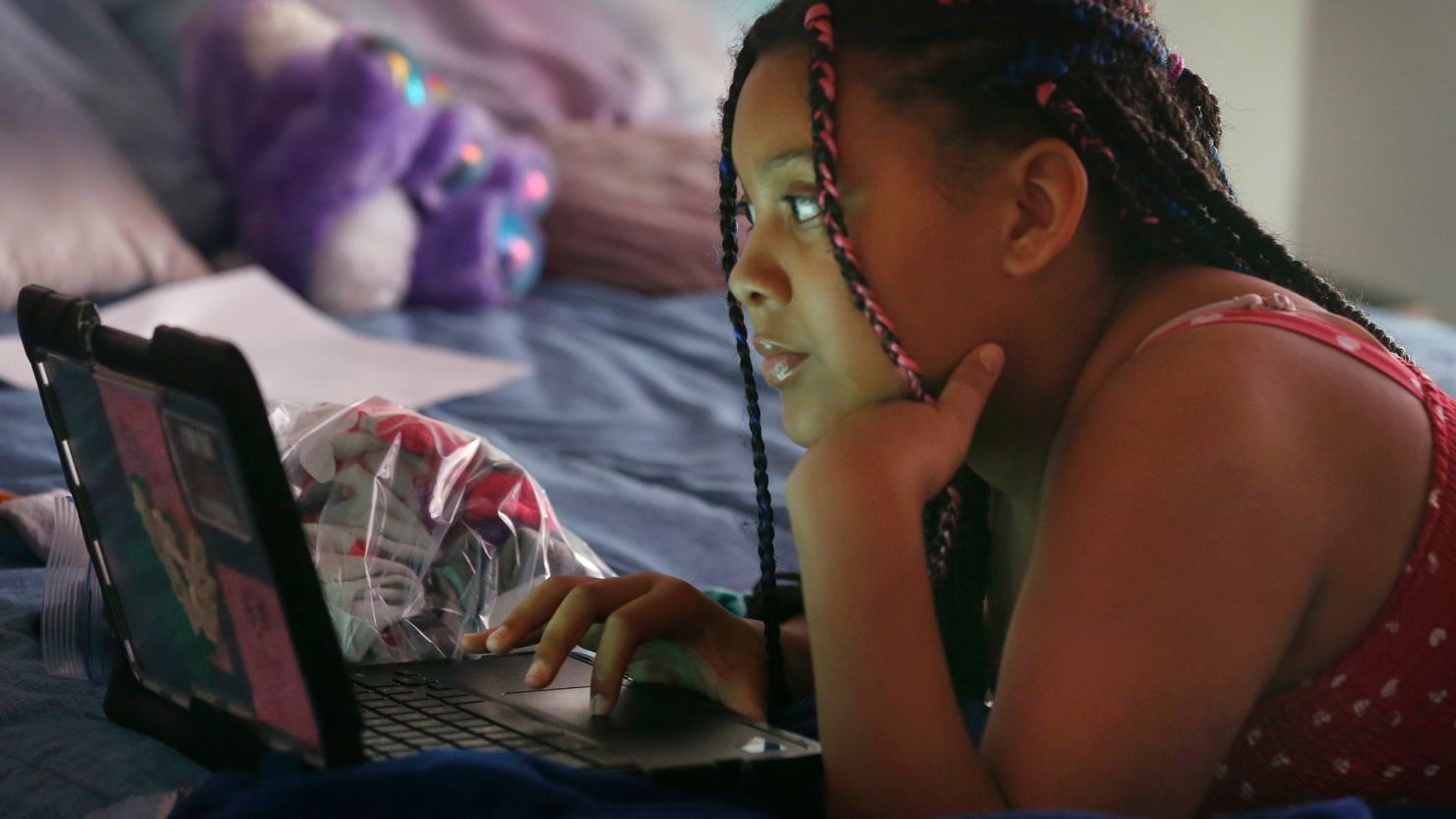 Alayjah Burnett, 13, attends an online class at her home in Vallejo, California on Thursday, April 23, 2020. Alayjah's mom, Michelle Burnett, says she's worried about the shift toward distance learning. "I just feel like she's going to get left in the dust," she says.