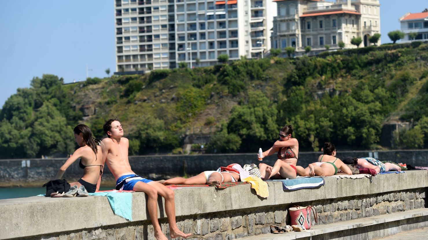 People sunbathe at the Cote des Basques beach in Biarritz in southwestern France. In Paris, temps reached 39 degrees Celsius (102 degrees Fahrenheit), a record for the year.