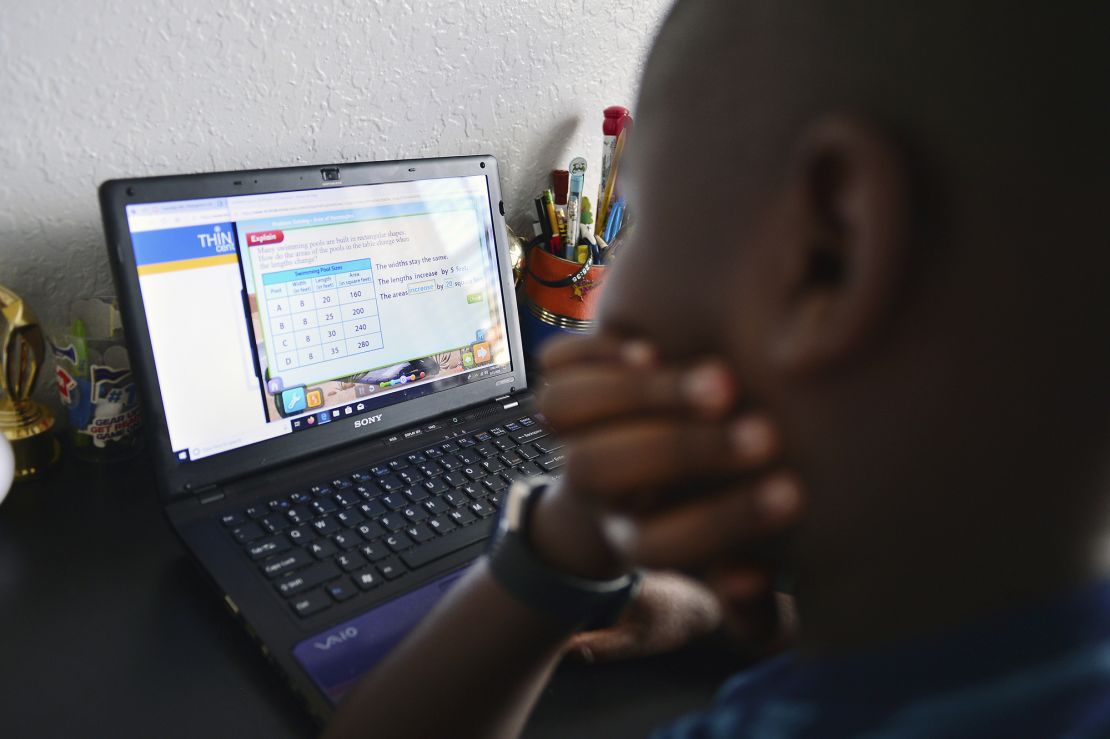Jordan, 9, works on his laptop in his bedroom  during distance learning in Broward County, Florida.