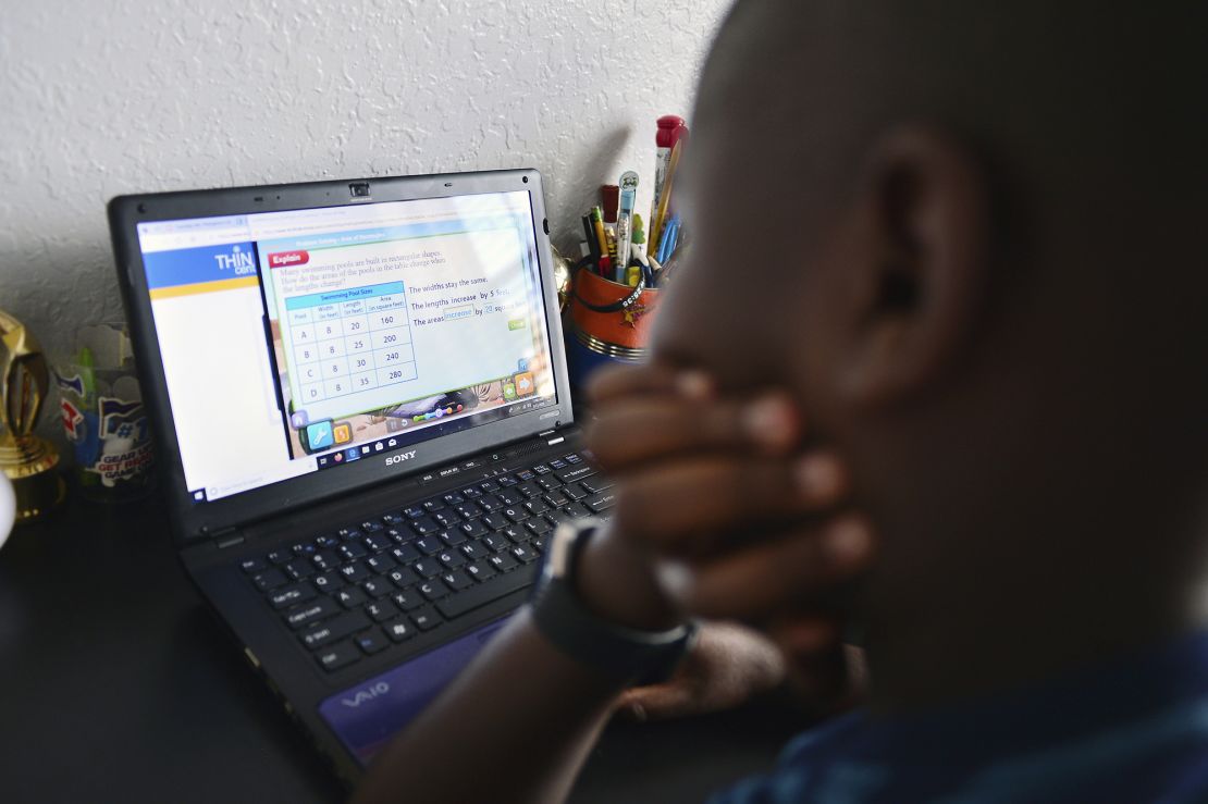 Jordan, 9, works on his laptop in his bedroom during distance learning in Broward County, Florida.