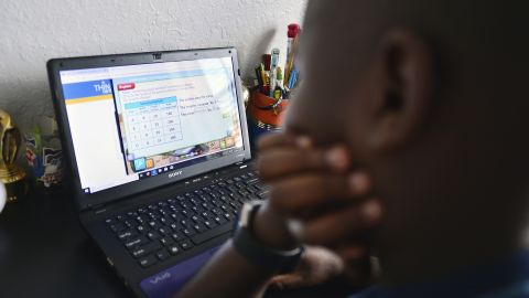 Jordan, 9, works on his laptop in his bedroom  during distance learning in Broward County, Florida.