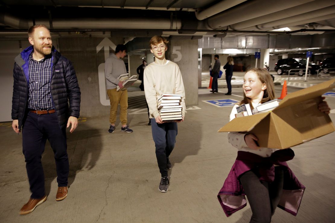 Jesse Todd of Mill Creek, Washington, walks with his kids after checking books out at the Seattle Public Library Central Branch before it closed. 