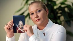 Virginia Giuffre holds a photo of herself at age 16, when she says Palm Beach multimillionaire Jeffrey Epstein began abusing her sexually. (Emily Michot/Miami Herald/Tribune News Service via Getty Images)