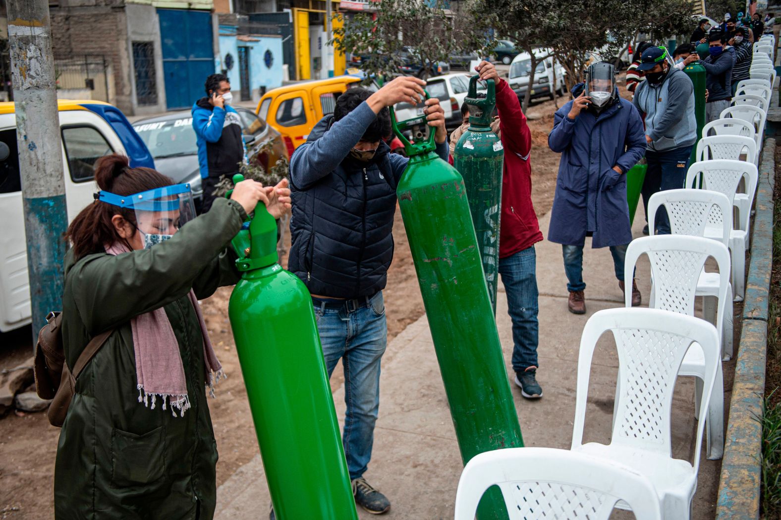 Relatives of Covid-19 patients line up to recharge oxygen cylinders in Villa Maria del Triunfo, Peru, on July 29.