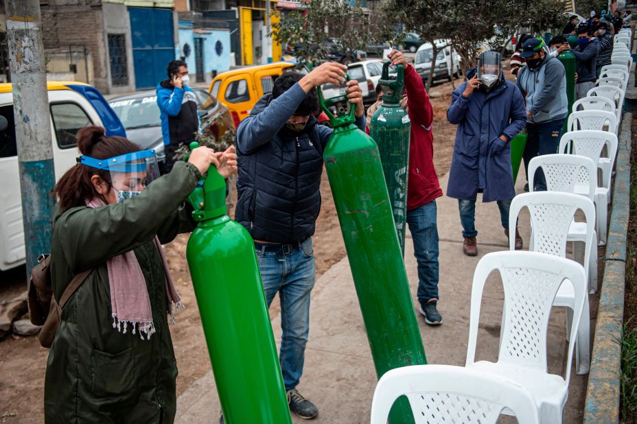 Relatives of Covid-19 patients line up to recharge oxygen cylinders in Villa Maria del Triunfo, Peru, on July 29.