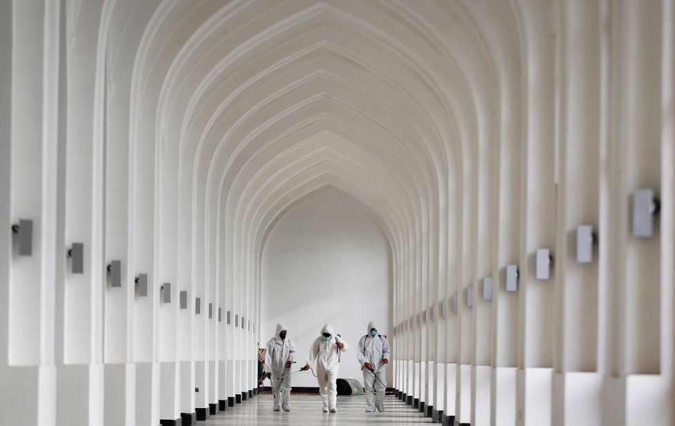 Volunteer health workers disinfect a mosque prior to Eid al-Adha prayers in Kabul, Afghanistan, on July 31.