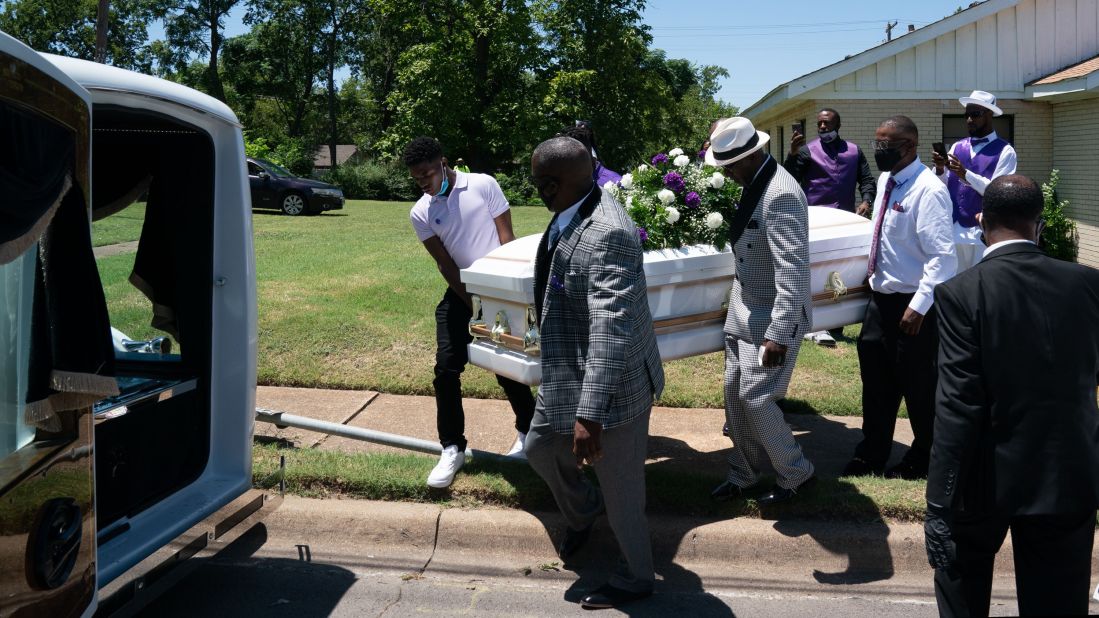 A casket carrying the body of coronavirus victim Lola M. Simmons is placed into a hearse following her funeral service in Dallas on July 30.