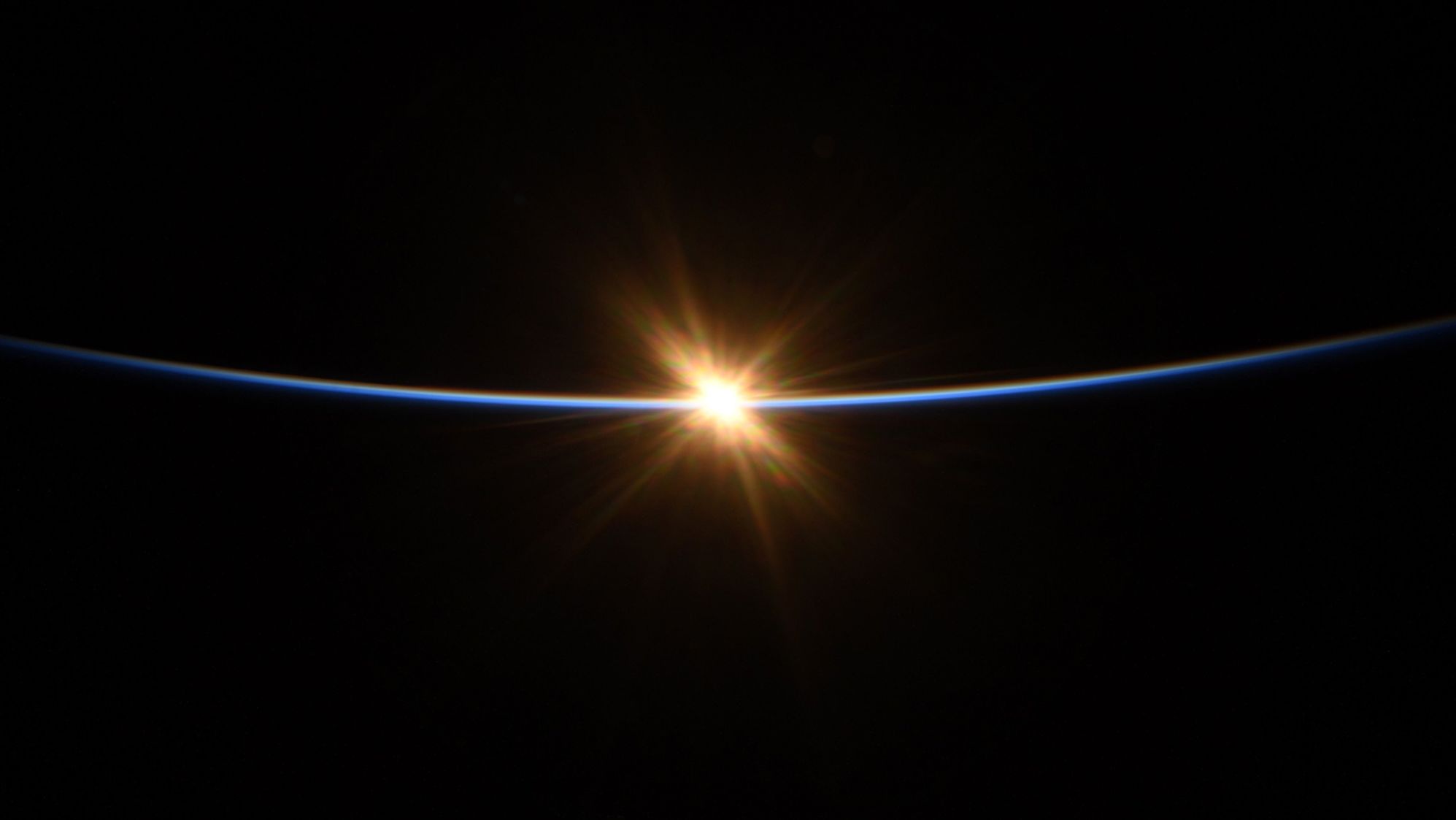 "First moments of sunrise from @Space_Station" as seen by Behnken on July 27.