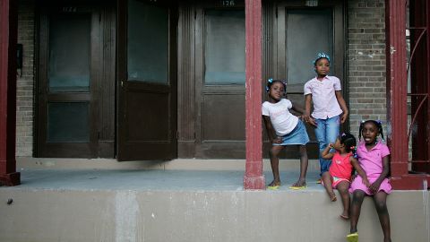 Sisters Corlia, Kayla, Aaliyah and Kaylen Smith stand on their front porch at the B.W. Cooper housing project in New Orleans.