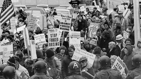 Demonstrators carry signs against forced school busing outside a convention of Democratic leaders in Louisville, Kentucky, on November 23, 1975.