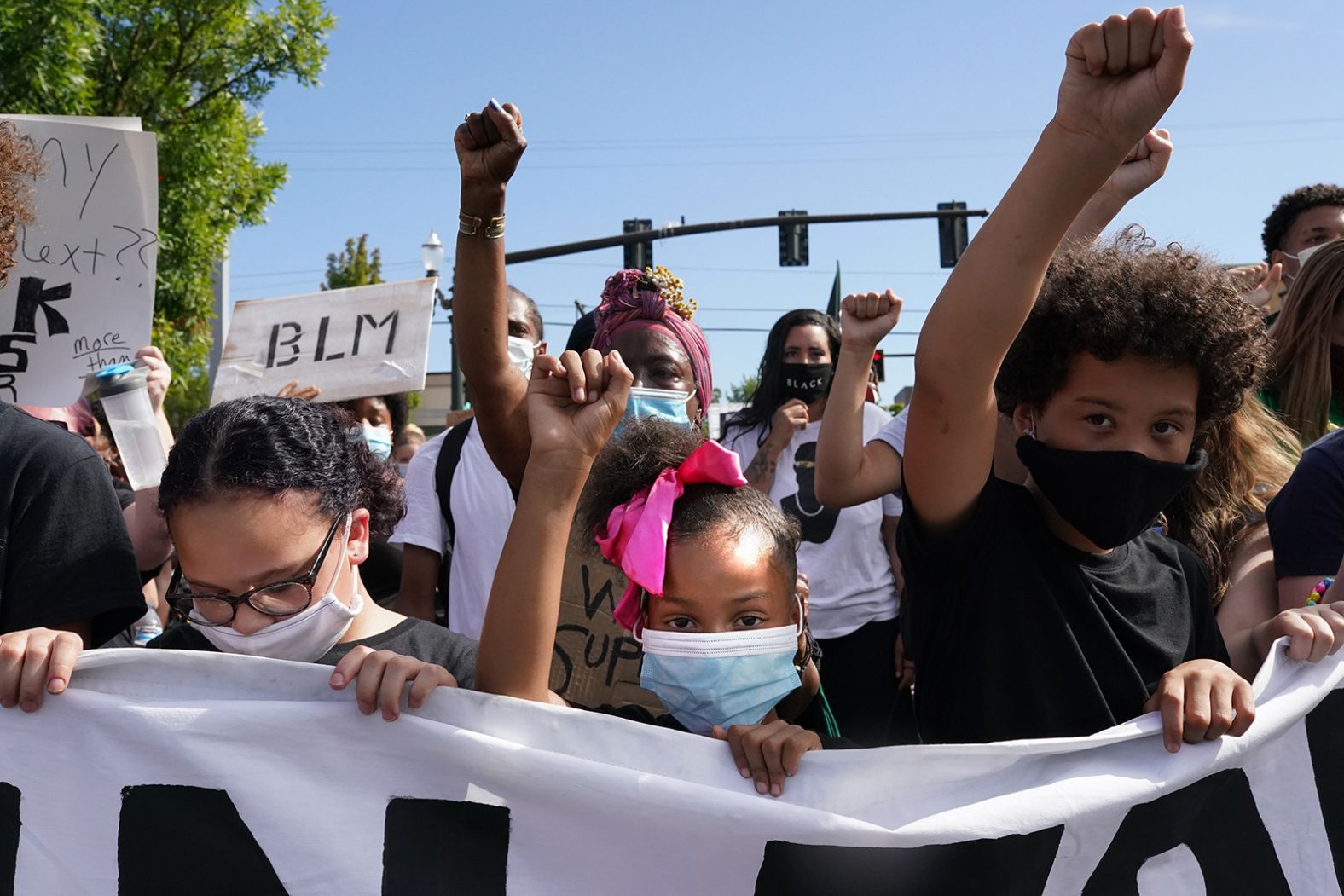 Protesters hold their fists in the air during a march on August 1.