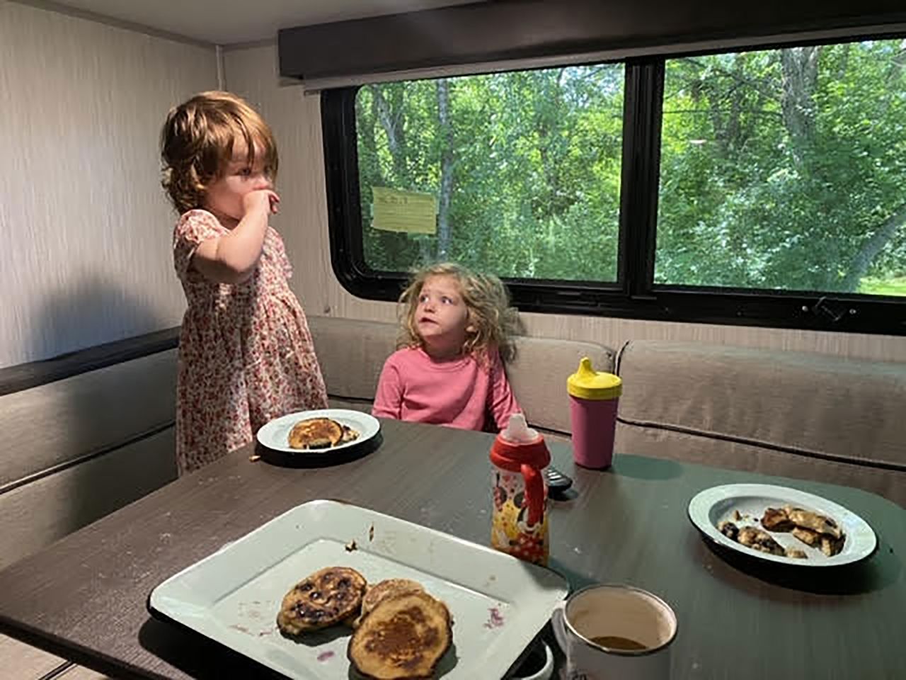 The Sherer children, Hendrix and Lennon, enjoy pancakes inside the family trailer.