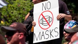 An anti-mask protestor holds up a sign in front of the Ohio Statehouse during a right-wing protest "Stand For America Against Terrorists and Tyrants" at State Capitol on July 18, 2020 in Columbus, Ohio. 