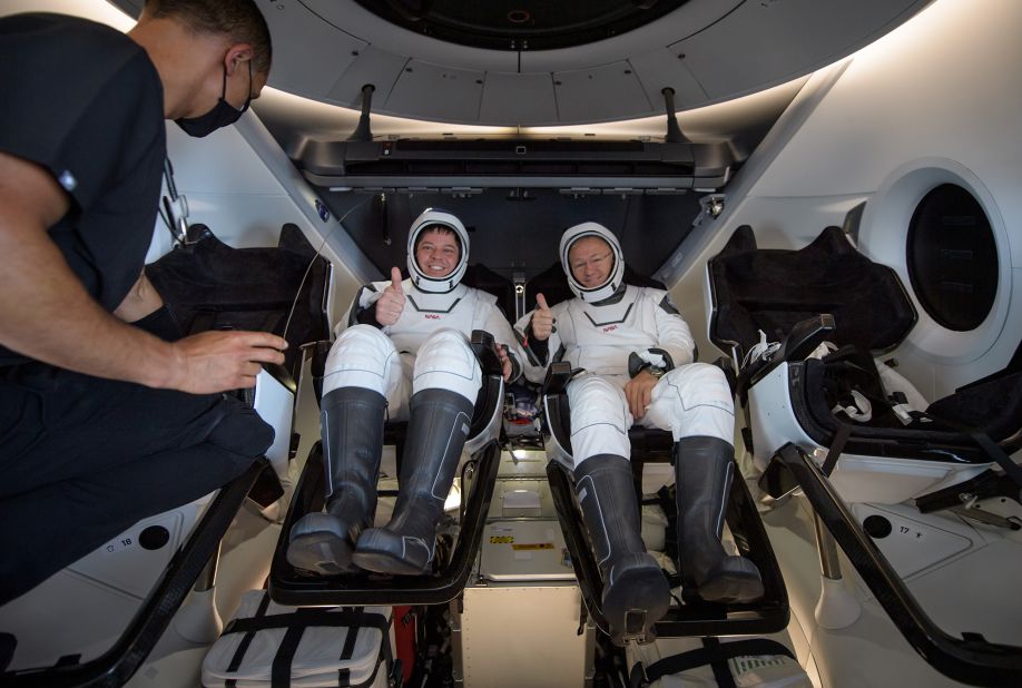 Behnken and Hurley give a thumbs-up before being extracted from the Crew Dragon spacecraft.