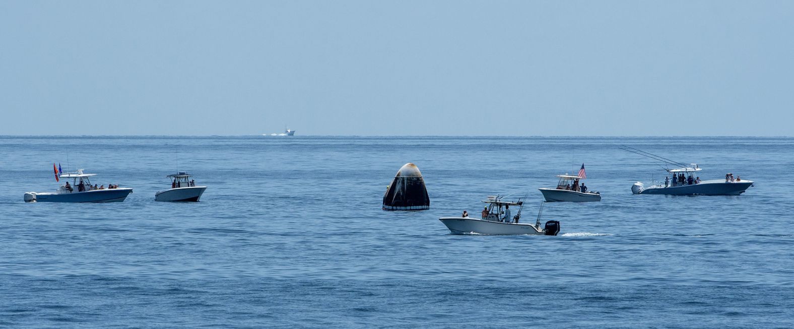 Boats swarm around the Crew Dragon shortly after splashdown. NASA Administrator Jim Bridenstine said during a <a href="index.php?page=&url=https%3A%2F%2Fwww.cnn.com%2F2020%2F08%2F02%2Ftech%2Fnasa-spacex-crew-dragon-mission-sunday-scn%2Findex.html" target="_blank">news conference</a> that the Coast Guard was supposed to keep a large swath of ocean around the landing site clear but that some boats made a "beeline" for the capsule. In a statement on August 2, the Coast Guard said, "With limited assets available and with no formal authority to establish zones that would stop boaters from entering the area, numerous boaters ignored the Coast Guard crews' requests and decided to encroach the area, putting themselves and those involved in the operation in potential danger."