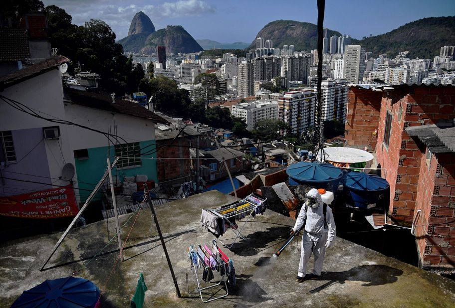 A volunteer disinfects a rooftop area in Rio de Janeiro on August 1.