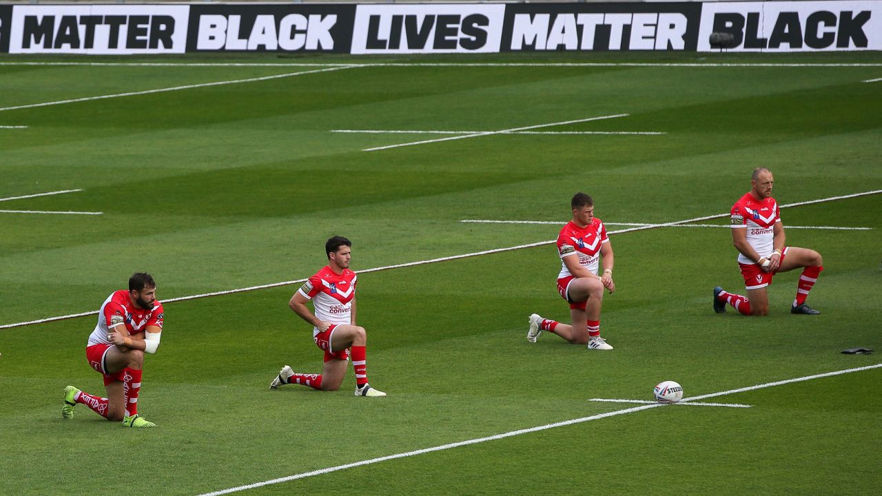 St Helens players take a knee before Sunday's game.