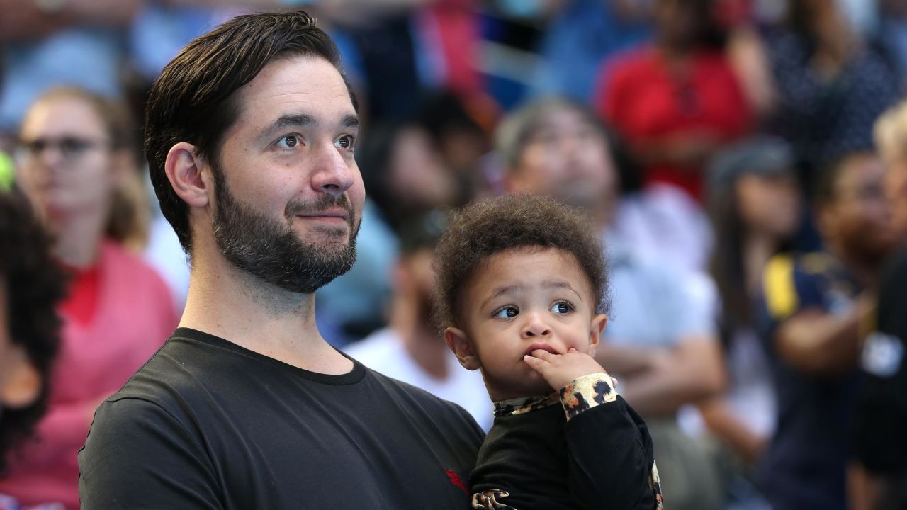 Ohanian holds Olympia while watching Williams at the Hopman Cup in 2019.