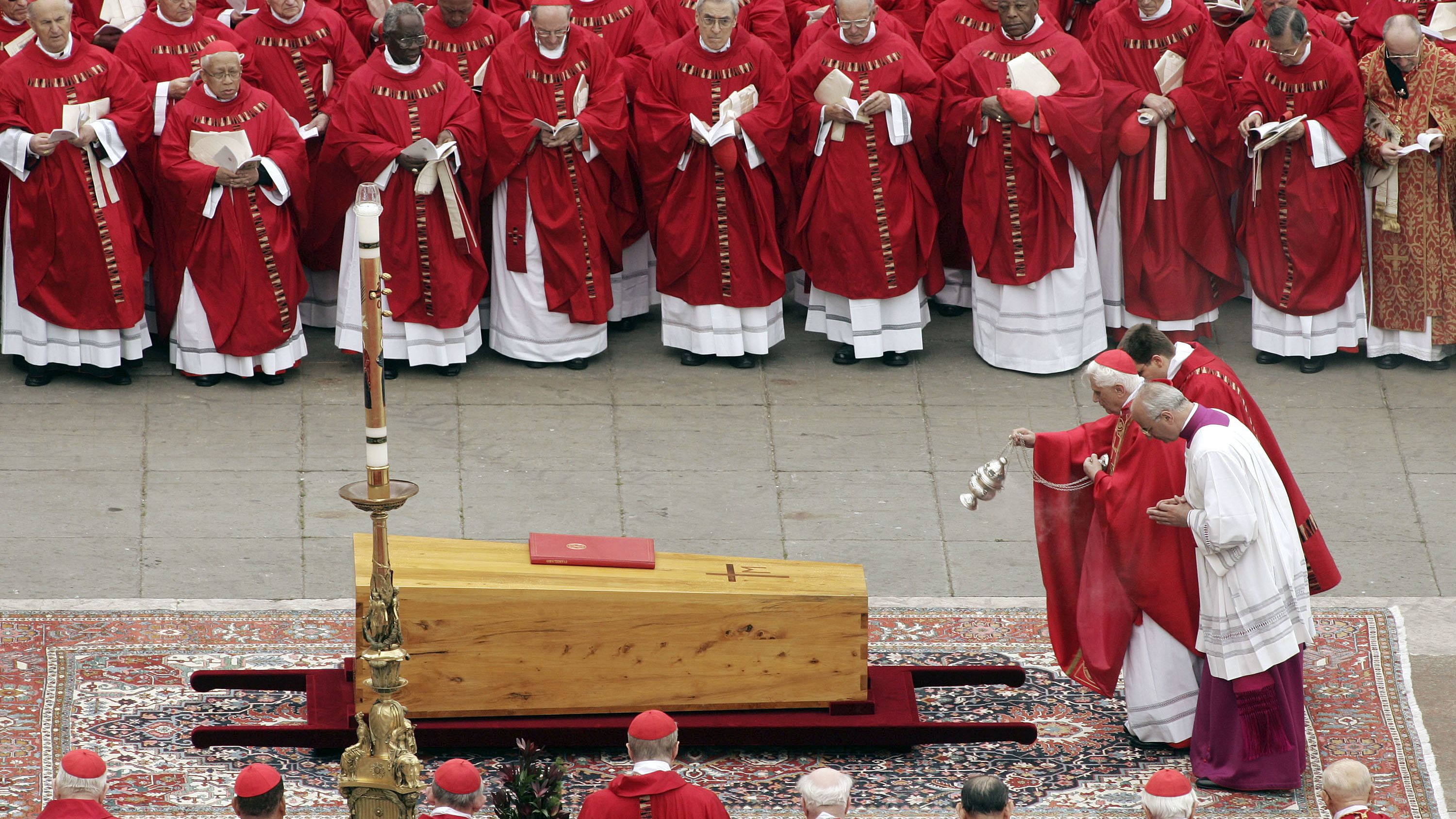 Benedict casts incense over the coffin of Pope John Paul II after his death.