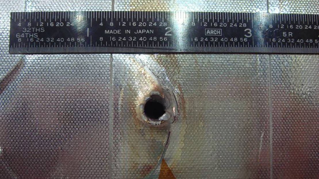 Space Shuttle Endeavour had a major impact on its radiator during STS-118. The entry hole is about 5.5 millimeters (0.22 inches), and the exit hole is twice as large.
