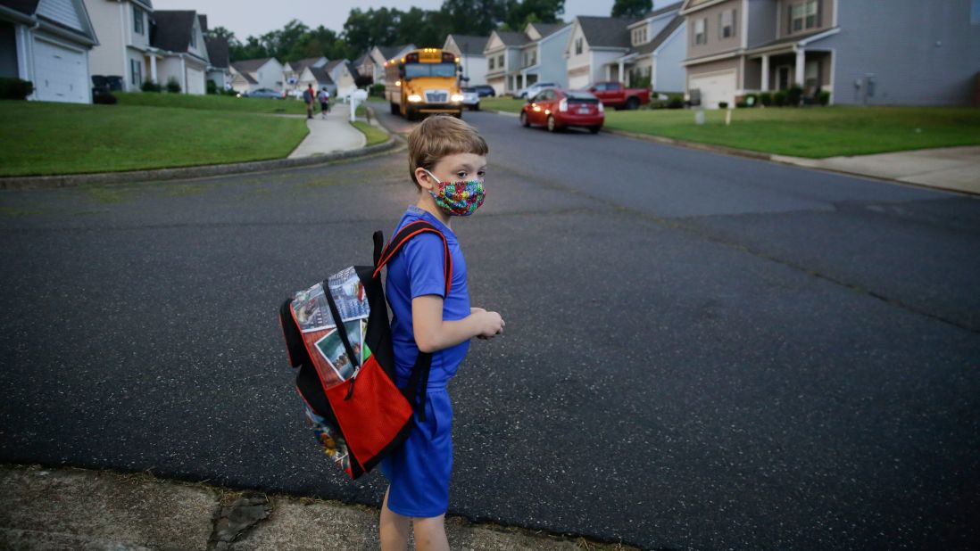 Paul Adamus, 7, waits at the bus stop for his first day of school in Dallas, Georgia, on August 3.