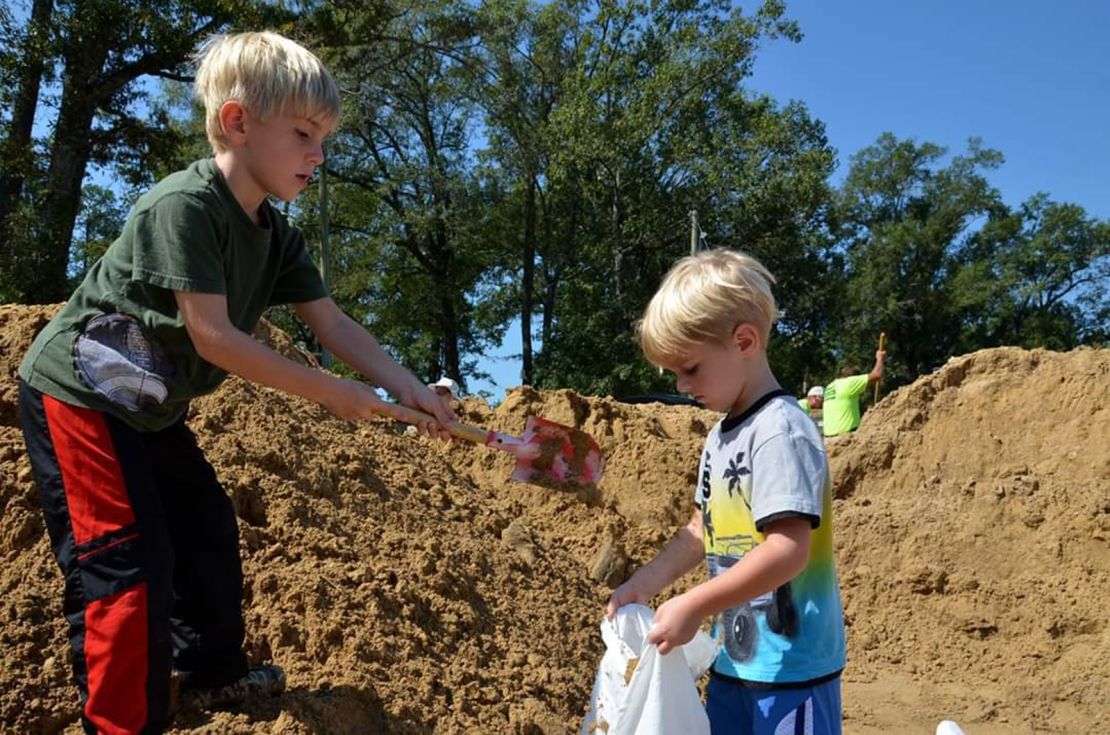 Greyson, left, volunteers with his brother Garrett.