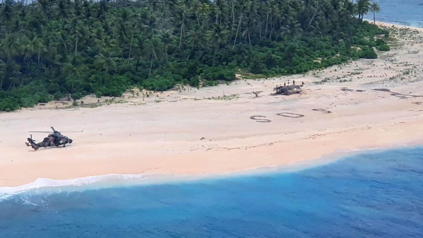 Three men from the Federated States of Micronesia on the beach of Pikelot Island, found after a combined US and Australian Search.Their SOS message outlined on a beach was spotted from the air by Australian and US aircraft searching the area.