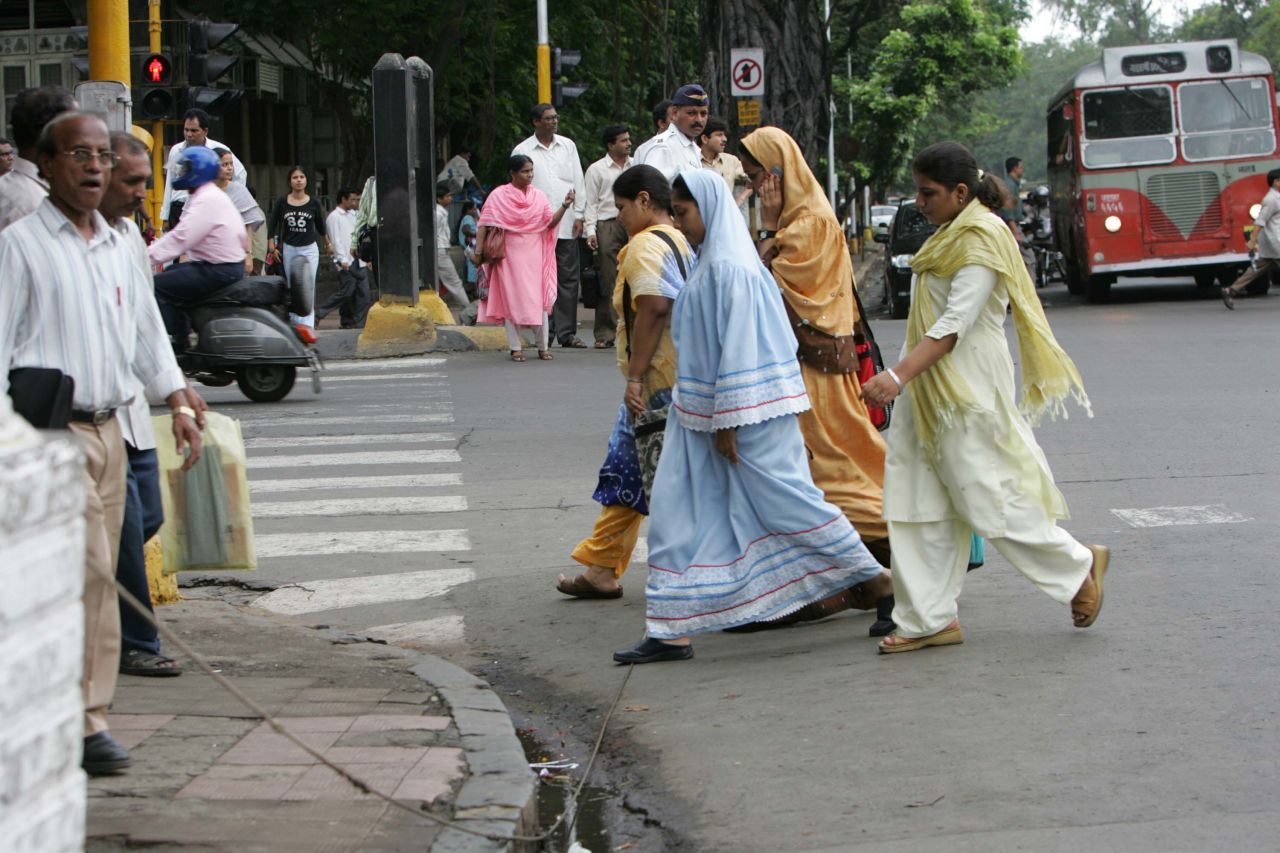 Pedestrians cross a street in Mumbai.