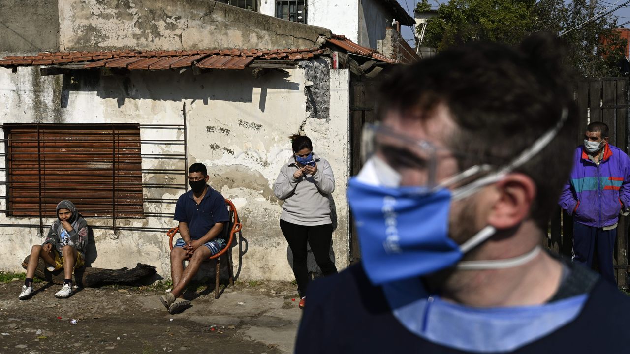 Locals wait for health volunteers on a visit to detect people with symptoms of Covid-19 in Villa Fiorito, Buenos Aires outskirts, Argentina, on August 3, 2020 amid the COVID-19 pandemic. Villa Fiorito has some 43,000 inhabitants and is hometown of former footballer Diego Maradona. Argentina surpassed 200,000 cases of Covid-19 on the eve, the Ministry of Health reported, and announced the ban on social gatherings throughout the country starting today. (Photo by Juan Mabromata/AFP/Getty Images)