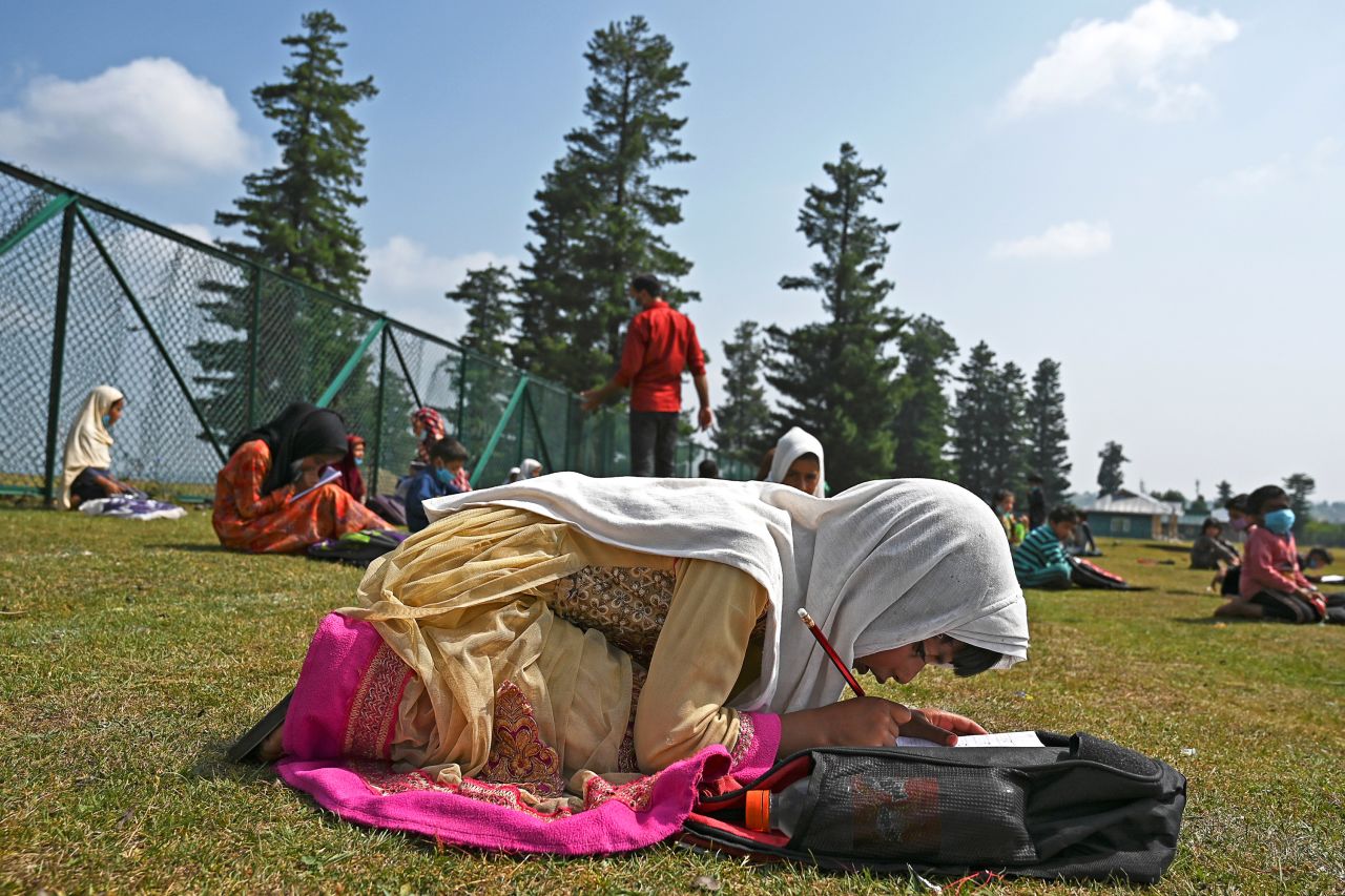 Students attend a class at their open-air school in Doodhpathri, in Indian-administered Kashmir, on July 27.