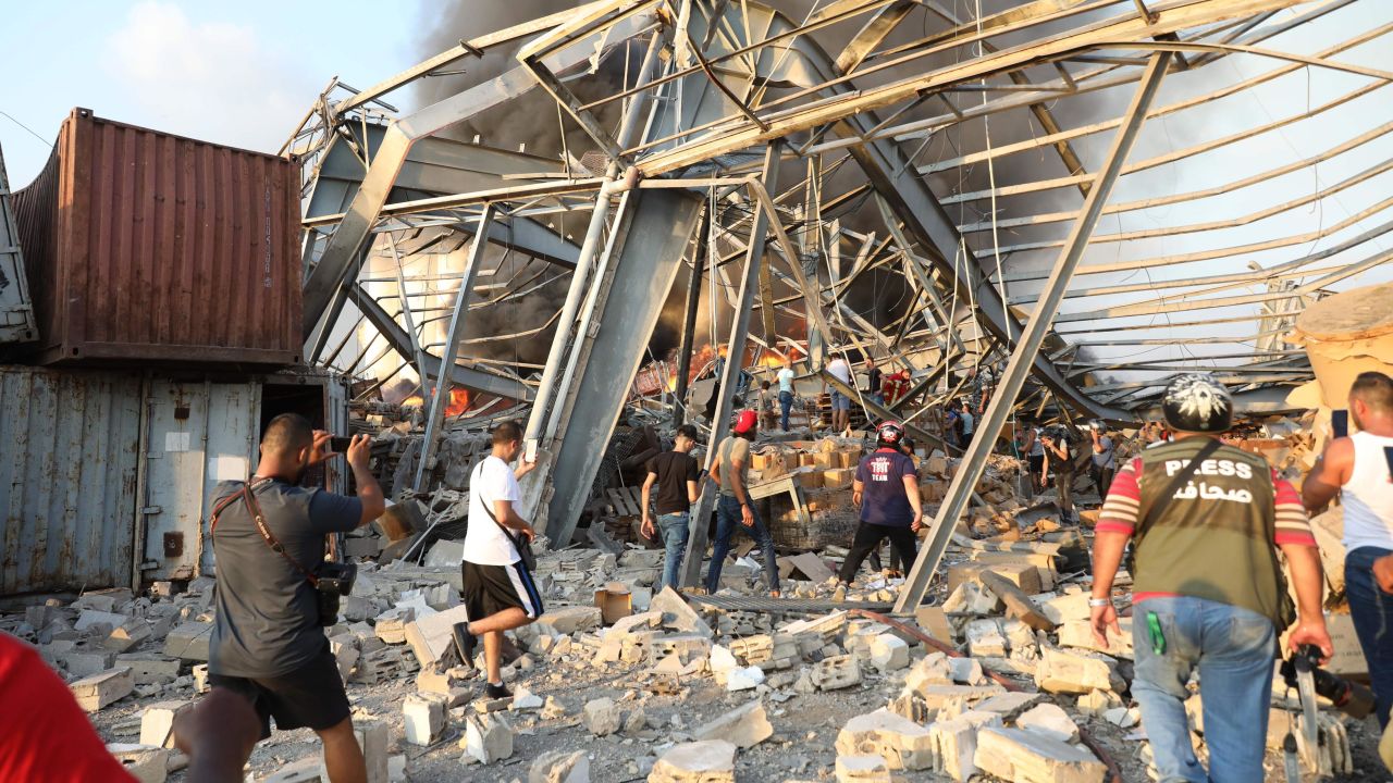 People walk at the scene of the explosion.