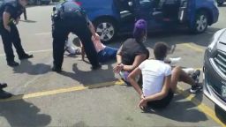 A Facebook video shows the children on the ground Sunday in a parking lot, surrounded by police.