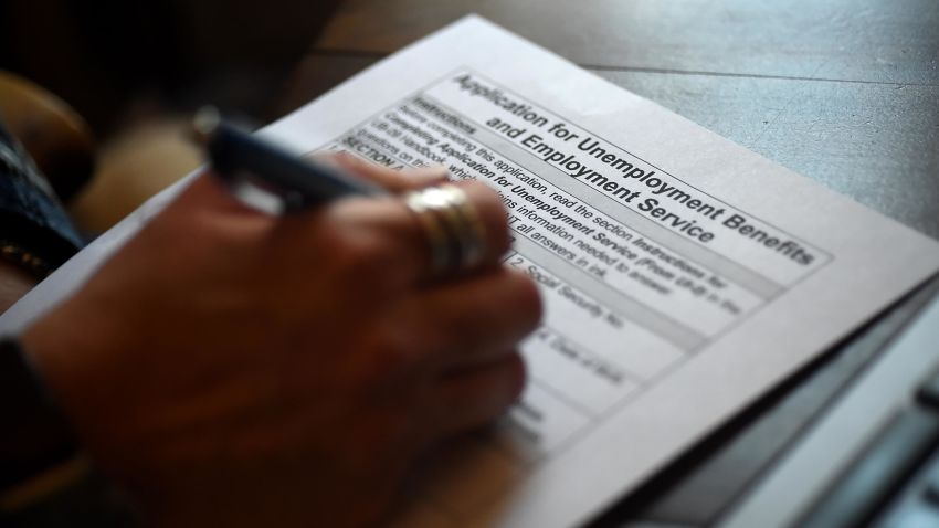In this photo illustration, a person files an application for unemployment benefits in April 2020 in Arlington, Virginia.