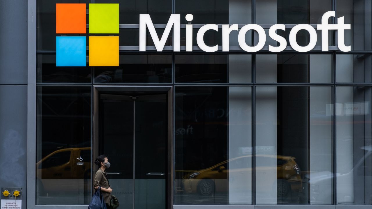 A pedestrian wearing a protective mask walks past a Microsoft Technology Center in New York, on Wednesday, July 22, 2020.