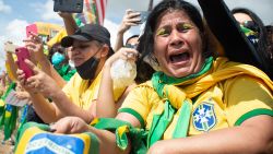 A supporter of Brazilian President Jair Bolsonaro cries during a demonstration in favor of his government amidst the coronavirus pandemic in front of Planalto Palace on May 24, 2020 in Brasilia, Brazil. (Photo by Andressa Anholete/Getty Images)