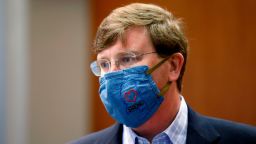 Gov. Tate Reeves sports a "Mississippi Strong" face mask following his coronavirus news briefing in Jackson, Miss., Wednesday, July 8, 2020. Reeves and other state officials provided reporters an update on the coronavirus and the state's ongoing strategy to limit transmission. (AP Photo/Rogelio V. Solis)